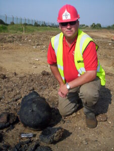 A young George Wood in BACTEC branding beside the Napoleonic-era mortars